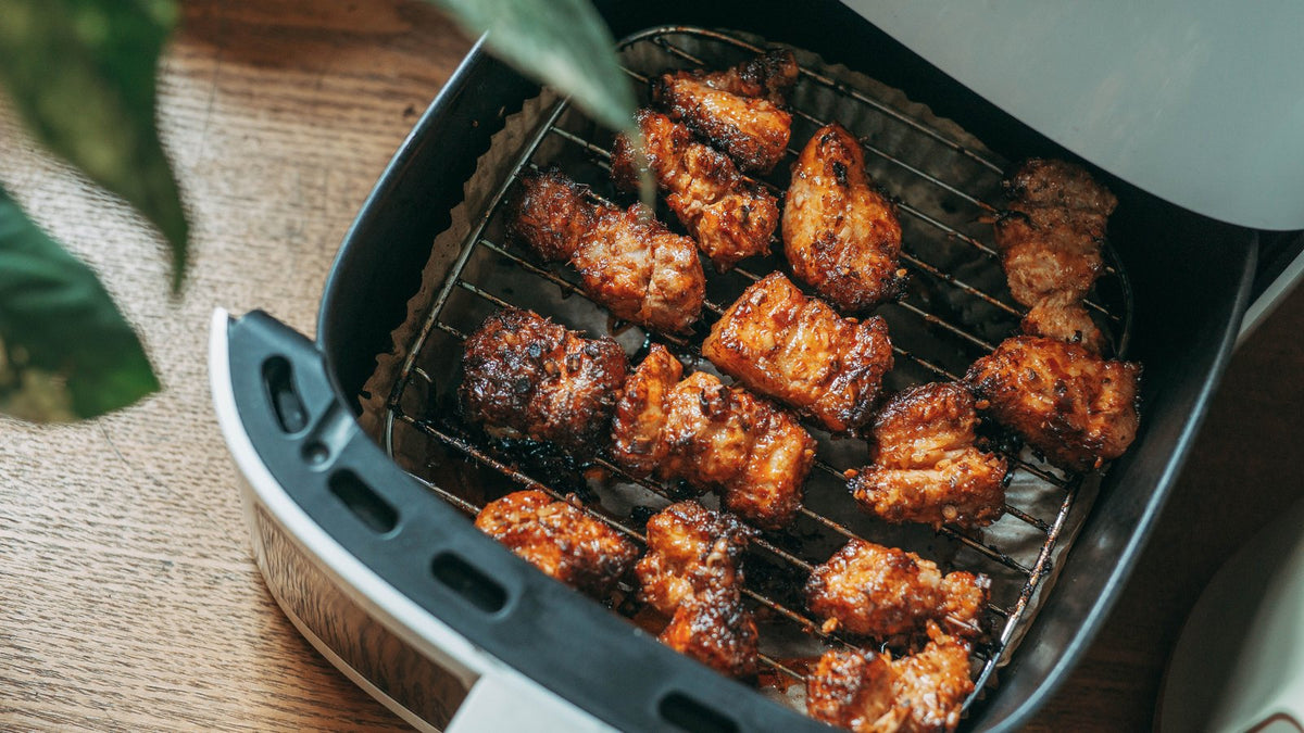 Crispy chicken wings in an open air fryer basket