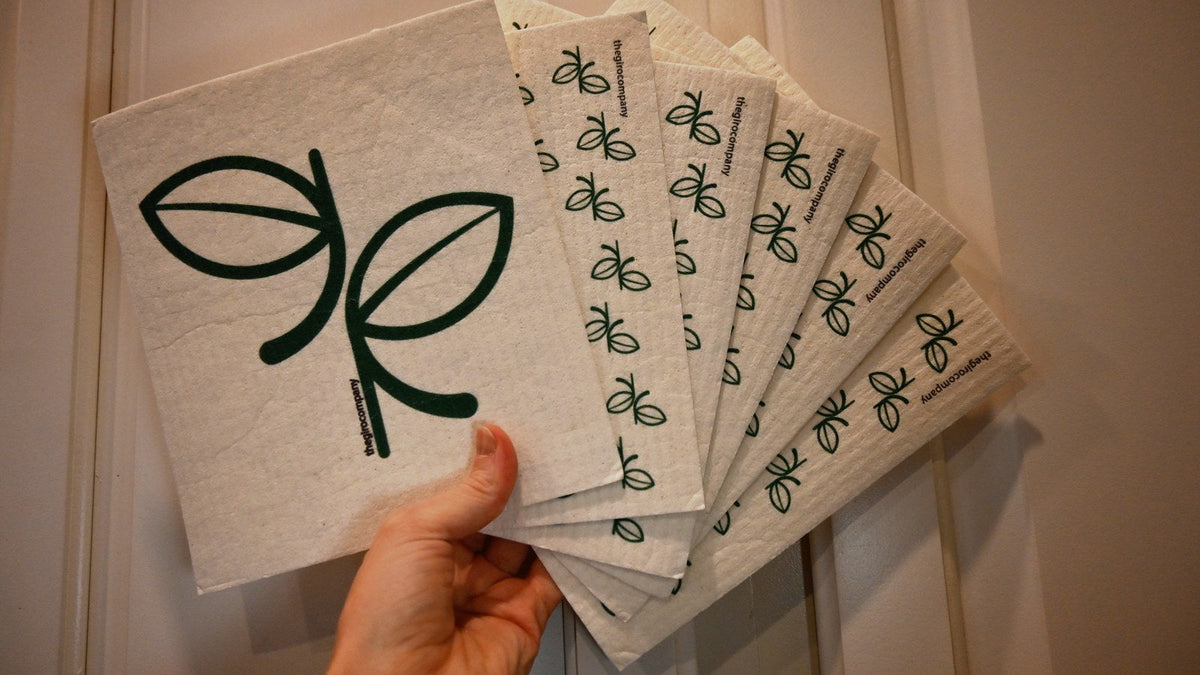 Hand fanning out a stack of Swedish dishcloths in two designs