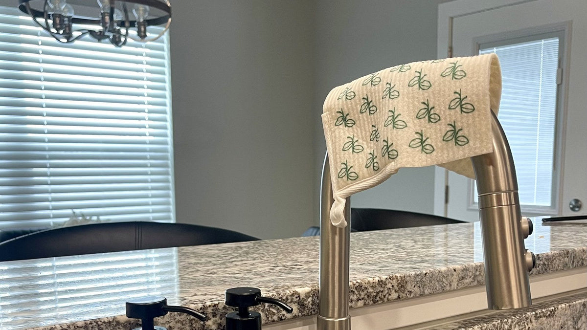 Swedish dishcloth air-drying over a kitchen faucet